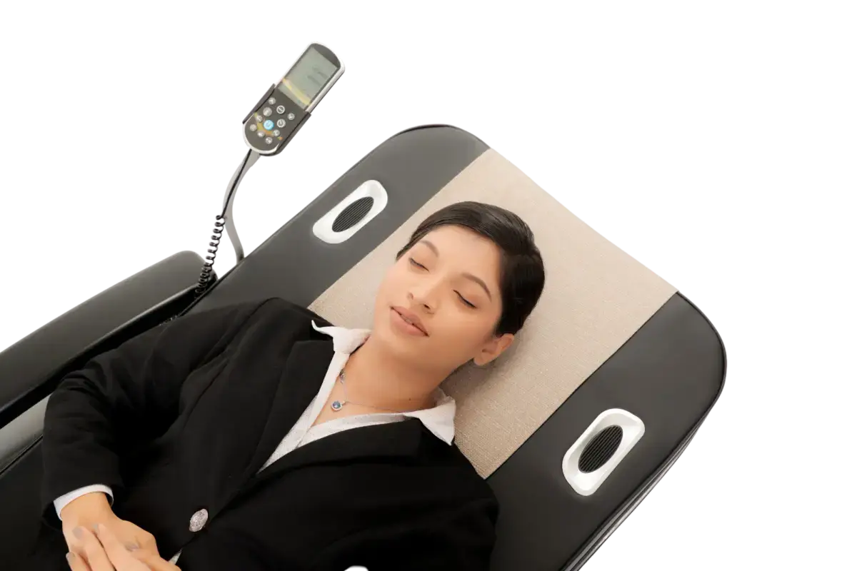 User relaxing on a SpineFit bed with the roller at the base of the neck