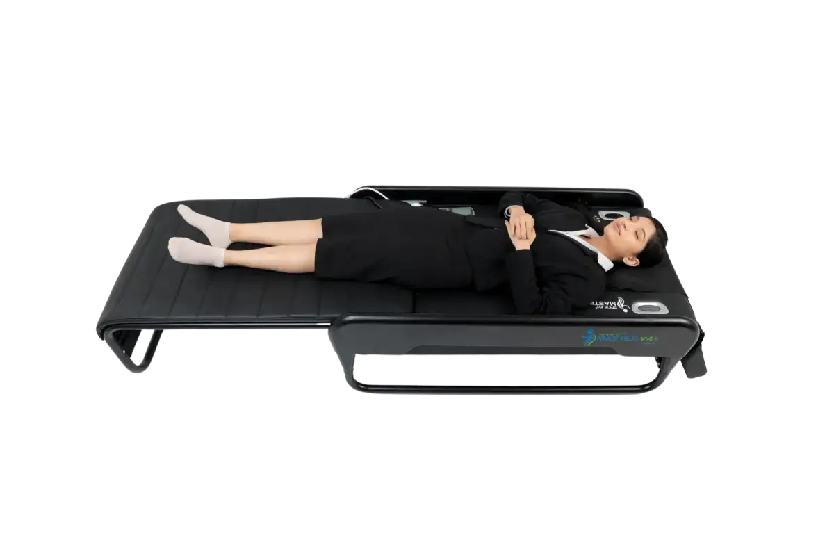 Person lying on a SpineFit Master V4+ bed while it maps the spine